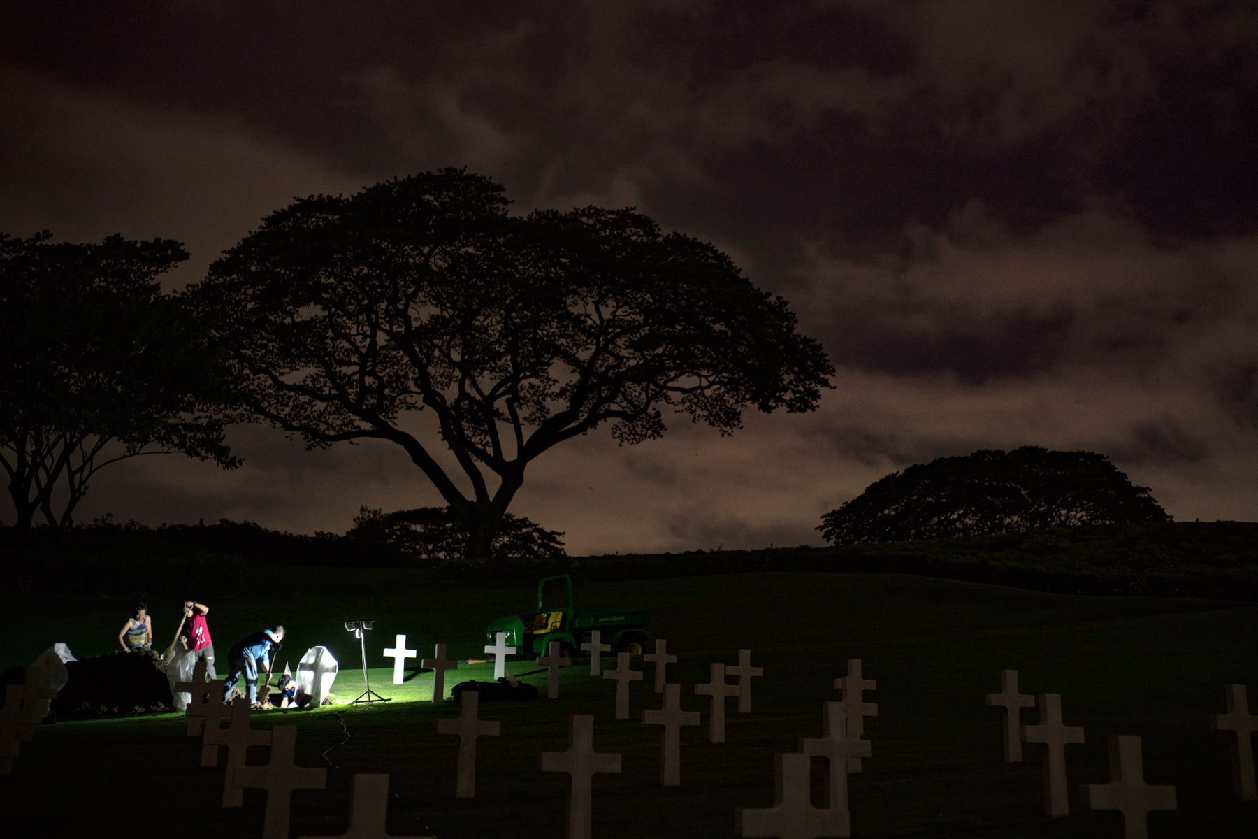 Local workers with the American Battle Monuments Commission (ABMC) uncover a casket at the Manila American Cemetery and Memorial in Manila, Philippines, June 6, 2018. ABMC worked with the Defense POW/MIA Accounting Agency (DPAA) to exhume the remains from 23 graves as part of DPAA’s effort to identify personnel that died in the Cabanatuan POW camp during WWII. (U.S. Air Force photo by Tech. Sgt. Kathrine Dodd)