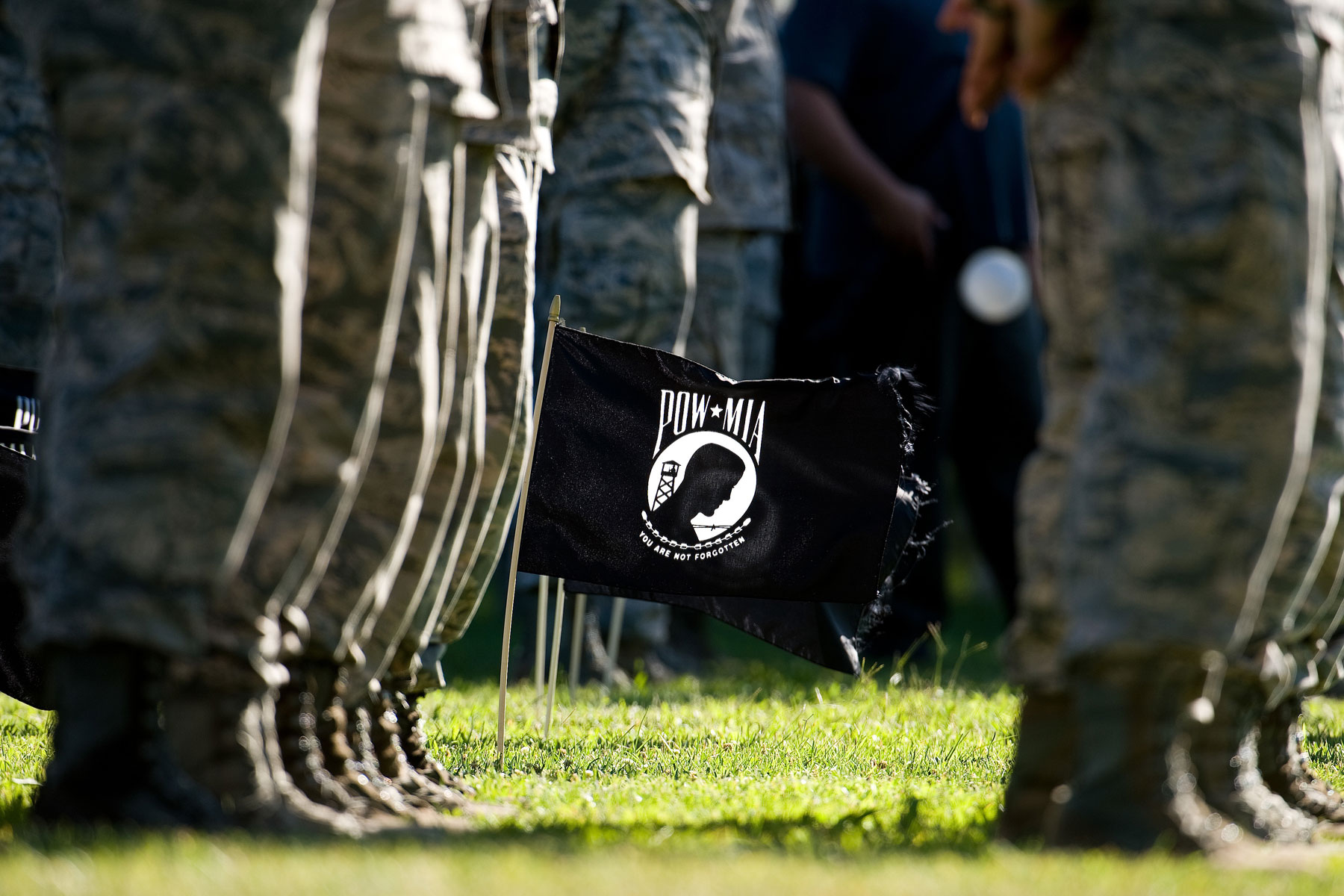 Twenty POW/MIA flags wave in a steady breeze during a retreat ceremony commemorating National POW/MIA Recognition Day Sept. 16, 2016, on Dover Air Force Base, Del. (U.S. Air Force photo by Roland Balik)