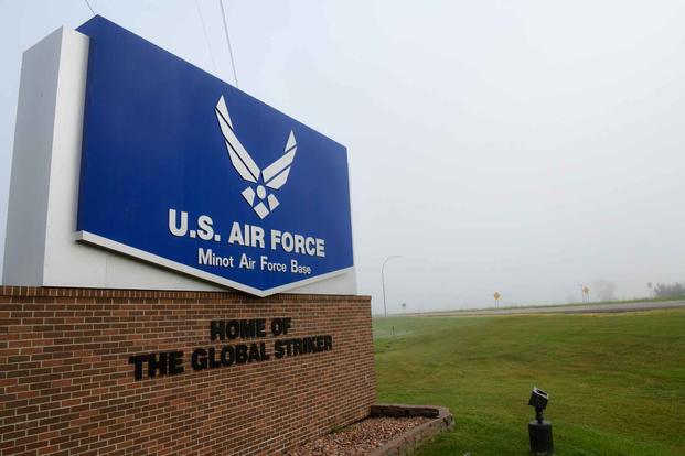 Heavy fog covers a sign at the front of the entrance at Minot Air Force Base.