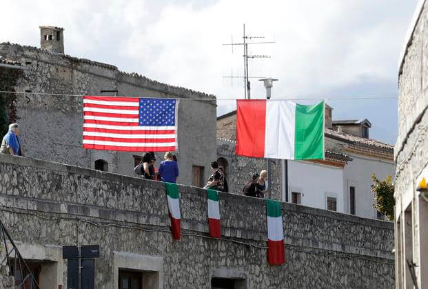 A United States flag and Italian flags hang in Pacentro, Italy