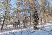 Soldiers and Marines prepare for a cold weather march using snowshoes while at Total Force Training Center Fort McCoy's Cold Weather Operations Course.