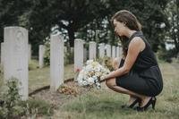 Grieving widow in cemetery