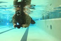 Recon Marine swims with fins at Camp Lejeune.