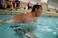 A future sailor and special warfare candidate swims during the Navy’s physical screening test.