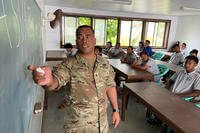 Staff Sgt. Gary Likiak instructs students in the Marshall Islands before they take the Armed Services Vocational Aptitude Battery test.