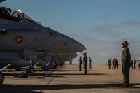 U.S. Marines prepare their F/A-18C Hornets to deploy
