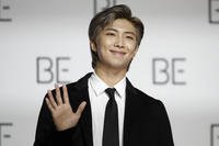 RM, a member of South Korean K-pop band BTS, poses for photographers in Seoul