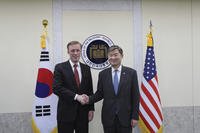 U.S. national security adviser Jake Sullivan, left, poses for a photo with his South Korean counterpart Cho Tae-yong