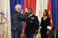 Earl G. Matthews recites the oath to be sworn into his new rank of colonel