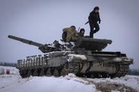 Ukrainian soldiers practice on a tank during military training in Ukraine