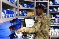 Spc. Chy Lee Ethridge, a pharmacy technician at Kimbrough Ambulatory Care Center, prepares medication requests