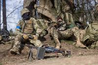 Ukrainian soldiers rest during military training in Poland
