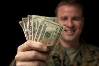 Soldier with handful of cash